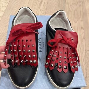 Prada black and red studded leather wedge platform sneakers.